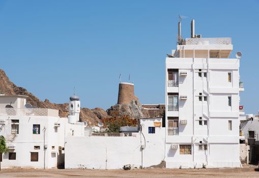 Residential area in Muscat, The Sultanate of Oman, with the ancient Fort  Al-Mirani in the background.
