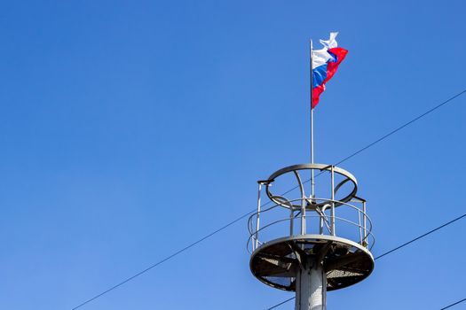 The flag of Russia on the observation deck of the column for technical purposes