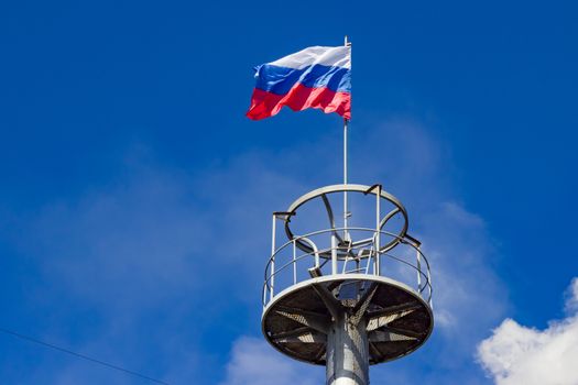 The flag of Russia on the observation deck of the column for technical purposes