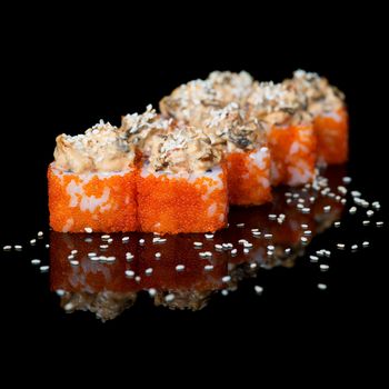 Sushi rolls with caviar and eel on  black background