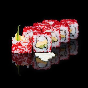 Sushi rolls with crab and omelet on  black background