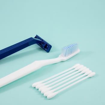 The purified white cotton buds with white toothbrush and dark blue plastic razor.