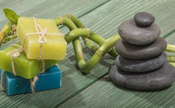 spa bamboo on green wooden background