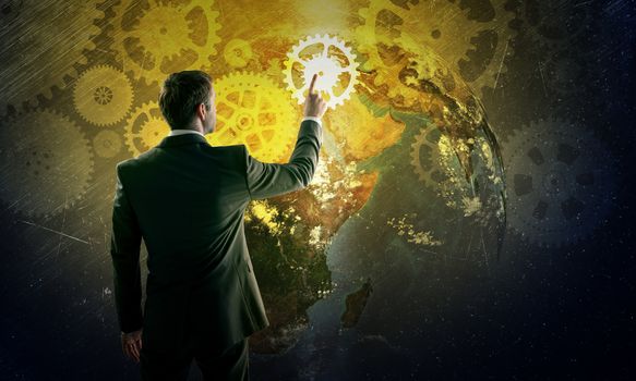Businessman in suit against digital background with icons, rear view. Elements of this image furnished by NASA