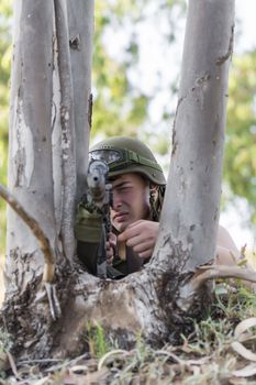 young a soldier in the uniform with weapon