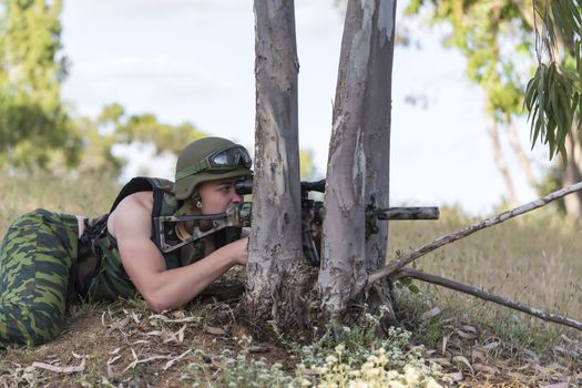 young a soldier in the uniform with weapon