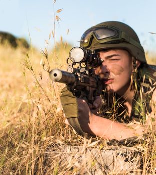 young a soldier in the uniform with weapon