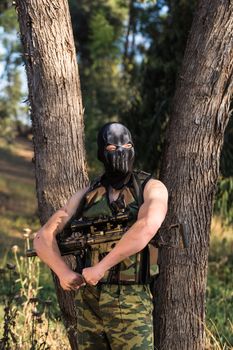 young a soldier in the uniform with weapon