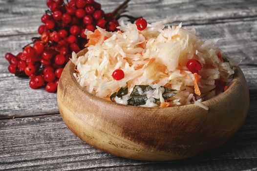 Fermented cabbage with spices in wooden tub in rustic style