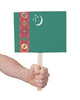 Hand holding small card, isolated on white - Flag of Turkmenistan