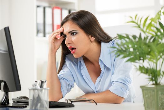 Stressed beautiful Businesswoman sitting in the office.