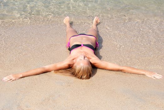 Beautiful young woman relaxing at beach