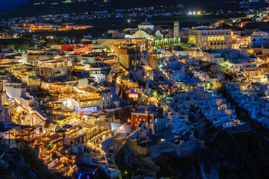 Illuminated Luxury balcony decks and patios of Fira at night, Santorini, Greece