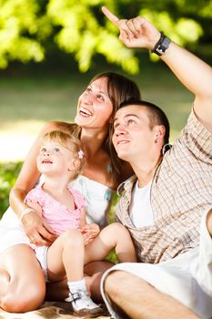 Beautiful happy family having fun in the park