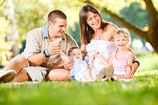 Beautiful happy family enjoying in the park