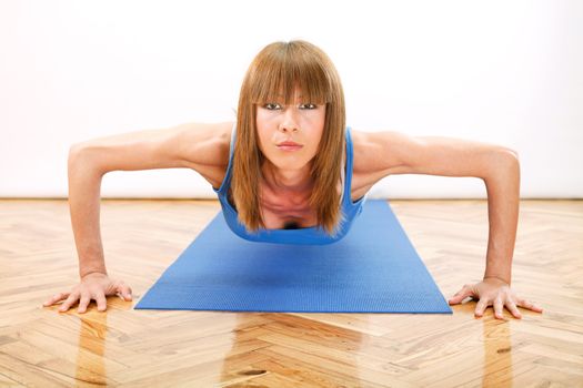 young beautiful girl doing push-ups