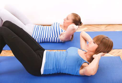 Two Fitnes girl doing abs exercise