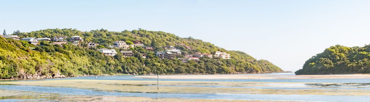 Panorama of Sedgefield and Swartvlei (Black Lake) with its mouth in the back. Luxury accommodation is visible on the hills next to the lake