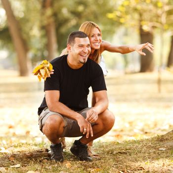 Young happy couple have fun in the park