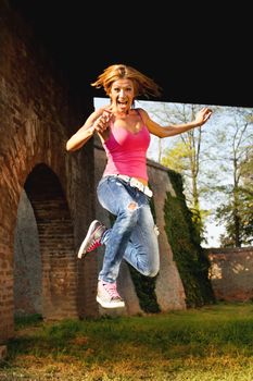Beautiful Happy Girl Jumping Outside