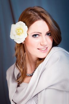 Portrait of beautiful woman with flower in her hair