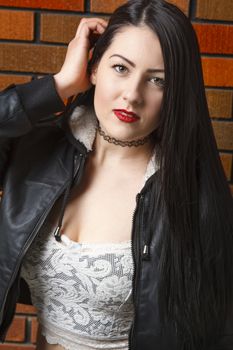 close up portrait on a twenty year old woman brushing back her hair