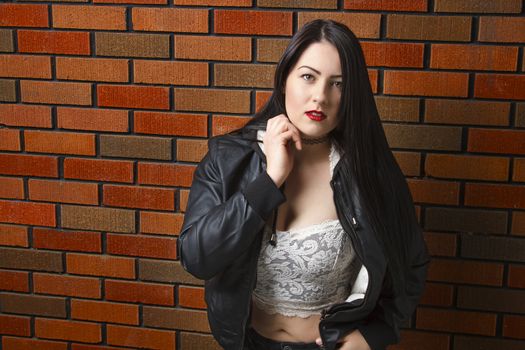 sexy twenty something girl with lace top against brick wall