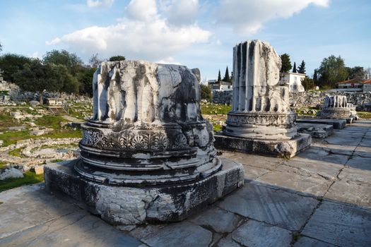 View of Didyma Ancient City in Aydın, Turkey, with granit columns and temple, on blue sky background.