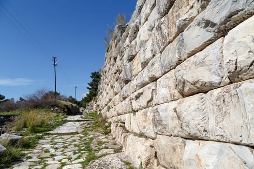 General temple view of Priene Ancient City in Aydın, Turkey, on bright blue sky background.