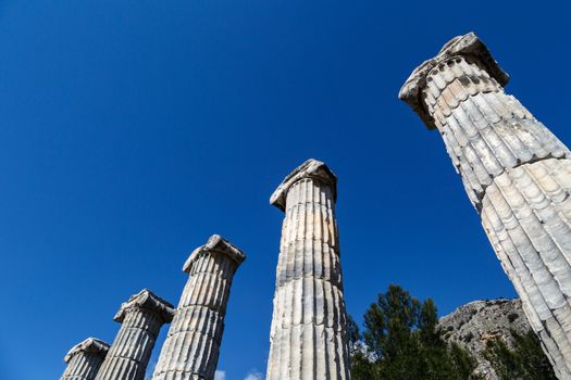 General temple view of Priene Ancient City in Aydın, Turkey, on bright blue sky background.