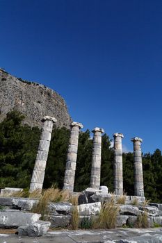 General temple view of Priene Ancient City in Aydın, Turkey, on bright blue sky background.