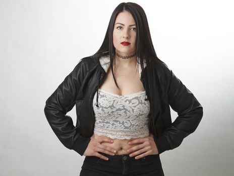 trendy twenty something woman wearing a lace top and a coat