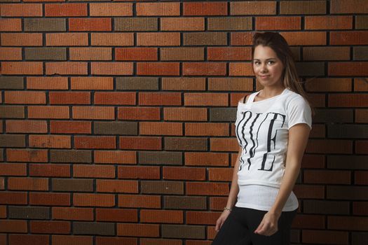 twenty something girl leaning against wall