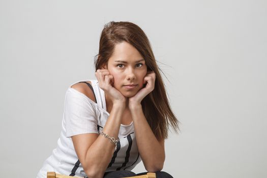 portrait of a teen girl holding her head in her hand