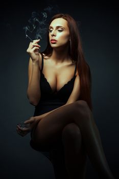 attractive sexy girl with cigarette dark scene, long hair