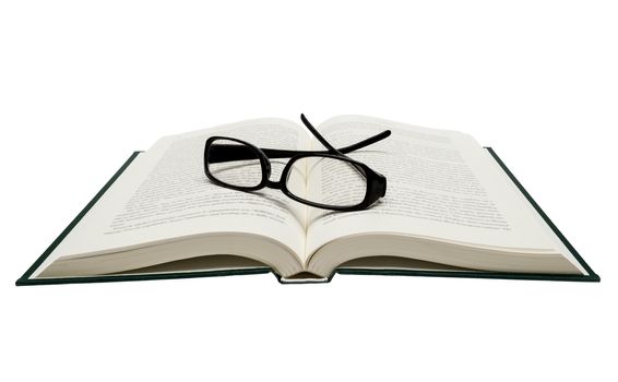 Horizontal shot of opened book with black framed glasses.