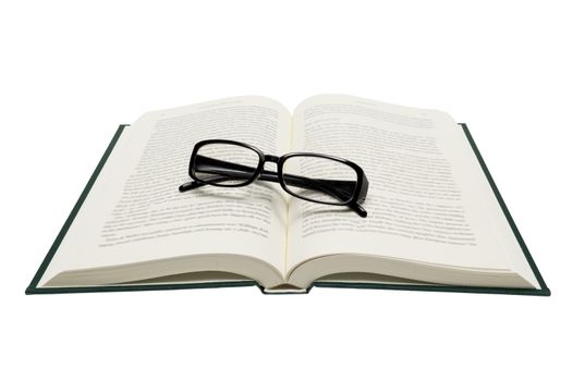 Horizontal shot of folded glasses on an opened book.  Isolated on white.