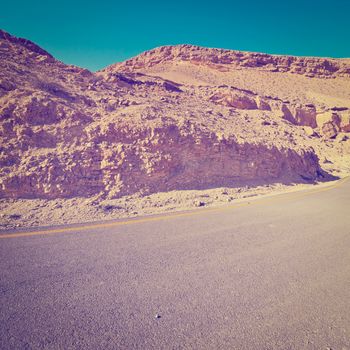 Asphalt Road above Grand Crater in Negev Desert, Retro Effect