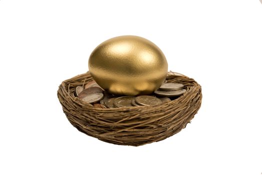 Golden egg laying on pile of coins.  Isolated on white