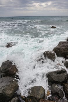 Not too big sea storm at rocky coast