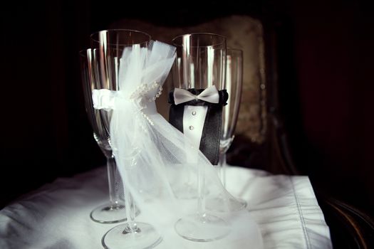four ceremonious wedding glasses with small dress