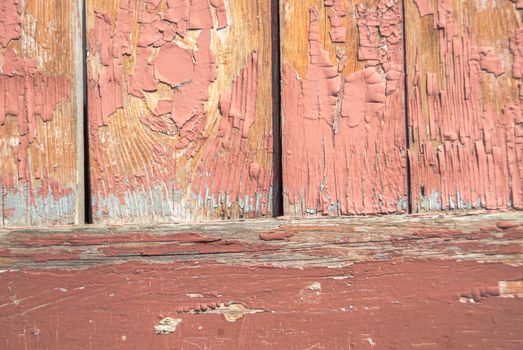 texture of wooden surface with remnants of old paint that has dried and cracked under the influence of weather