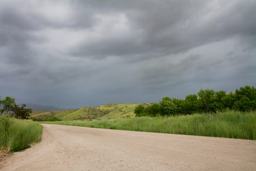 Road into the storm with dark clouds 