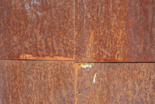 rusty iron surface covered with old chipped paint, which has long been influenced by different climatic conditions