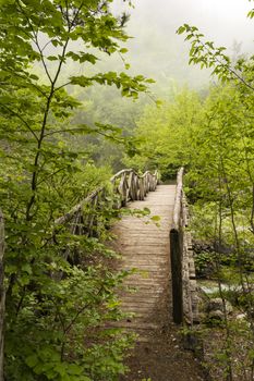 Wooden bridge over a river in the mountains of Olympus at Greece