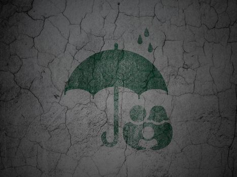 Safety concept: Green Family And Umbrella on grunge textured concrete wall background