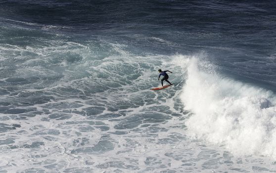 SAO VINCENTE,PORTUGAL-MARCH 24 Unidentified boy surfing on the big waves at the north coast of Madeira on MArch 23,2016 in Sao Vincente,Sao Vincente had the biggest waves at the portugal coast