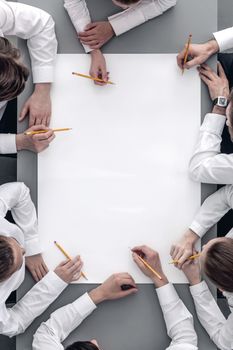 Business people at meeting around the table with blank paper