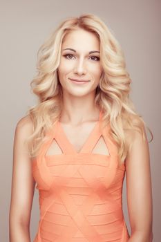 portrait blonde young smile girl in orange clothes