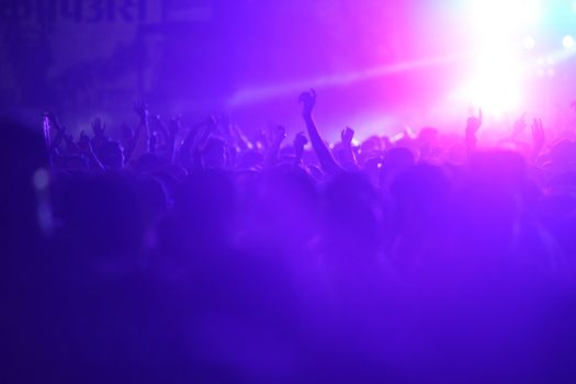 People dancing and enjoying at a huge musical concert in India.